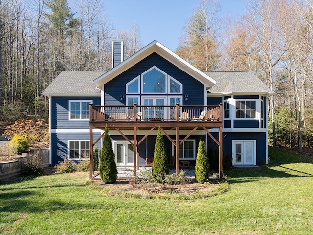 back of house featuring a deck and a yard