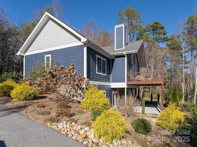 view of side of home with a deck