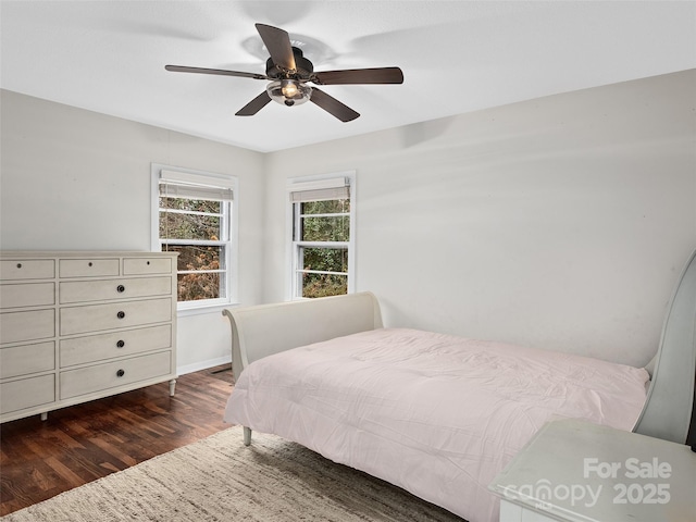 bedroom with ceiling fan and dark hardwood / wood-style flooring