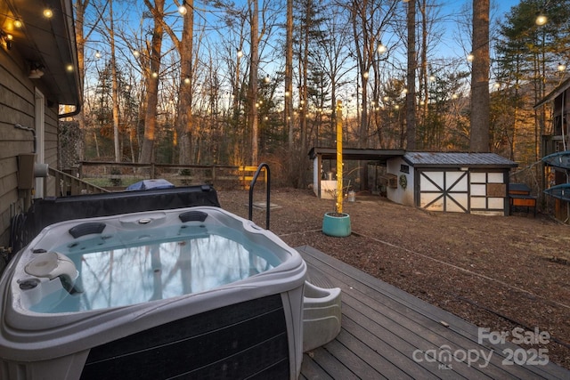 deck at dusk with a storage shed and a hot tub