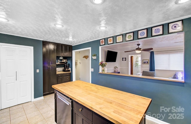 kitchen featuring refrigerator, light tile patterned floors, butcher block counters, a ceiling fan, and a textured ceiling