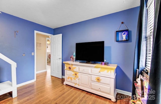 interior space featuring light wood-style flooring and baseboards