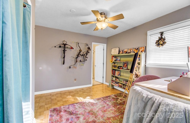 bedroom featuring ceiling fan and baseboards