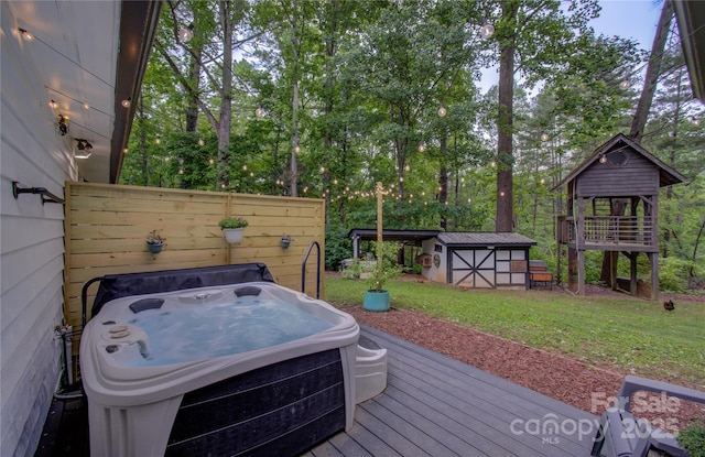 6 Candor Dr, Fletcher, NC 28732 - wooden deck with a hot tub, a storage shed, an outbuilding, grilling area, and view of wooded area