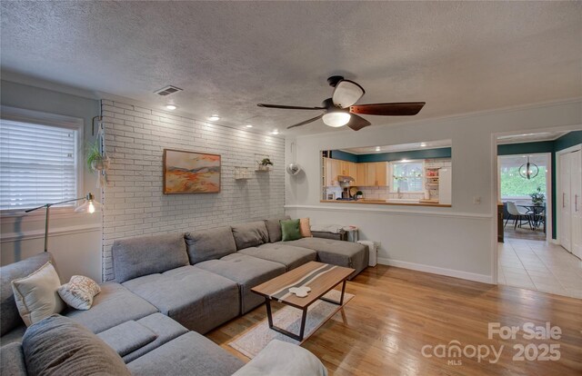 6 Candor Dr, Fletcher, NC 28732 - living area with a ceiling fan, light wood-type flooring, a textured ceiling, brick wall, and baseboards