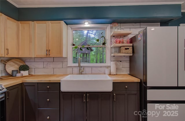 6 Candor Dr, Fletcher, NC 28732 - kitchen featuring butcher block countertops, a sink, freestanding refrigerator, tasteful backsplash, and crown molding