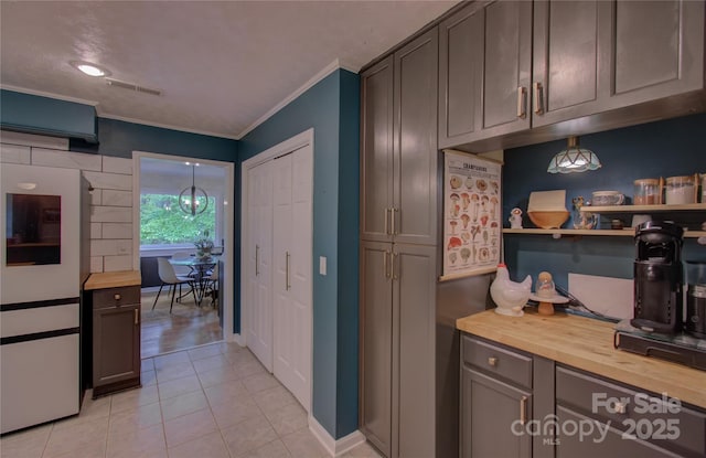 6 Candor Dr, Fletcher, NC 28732 - kitchen featuring wood counters, crown molding, light tile patterned flooring, and baseboards