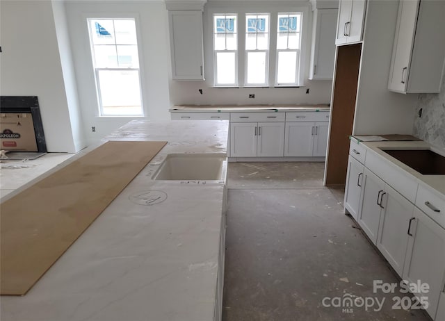 kitchen with white cabinetry and a sink