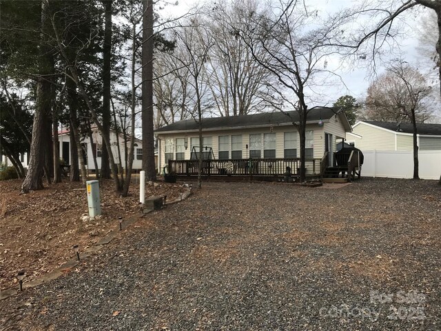 135/137 Indian Harbor Trl Unit E16/17, Mount Gilead, NC 27306 - view of front facade featuring a deck and gravel driveway