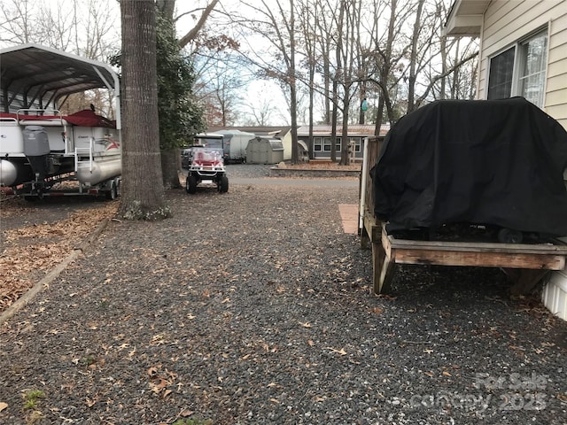 135/137 Indian Harbor Trl Unit E16/17, Mount Gilead, NC 27306 - view of yard featuring a carport