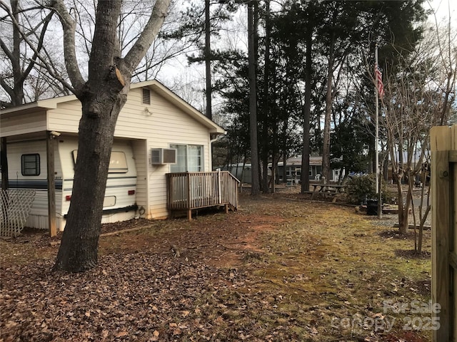 135/137 Indian Harbor Trl Unit E16/17, Mount Gilead, NC 27306 - view of yard with an AC wall unit and a wooden deck