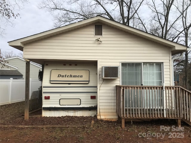 back of house with a wall mounted AC