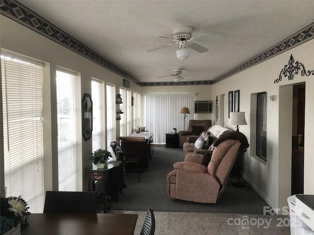 living room featuring carpet, ceiling fan, a textured ceiling, and a wall mounted AC