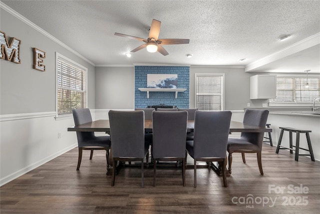 dining area with a textured ceiling, ceiling fan, dark wood-style flooring, and crown molding