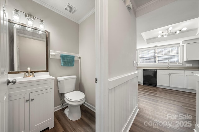 bathroom with toilet, wood finished floors, visible vents, and ornamental molding