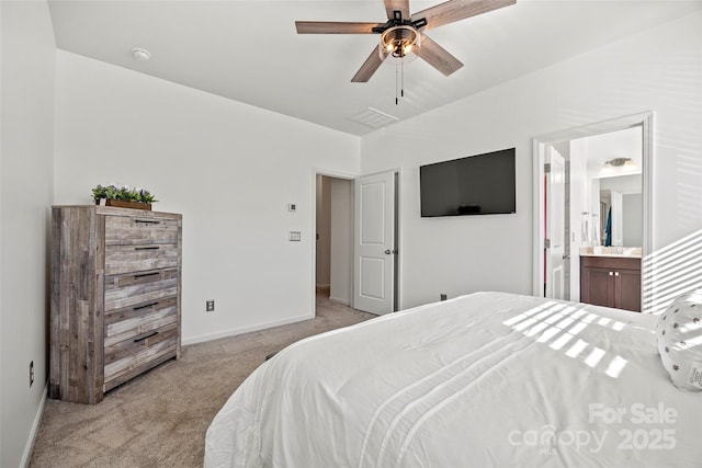 bedroom with ensuite bathroom, ceiling fan, and light colored carpet