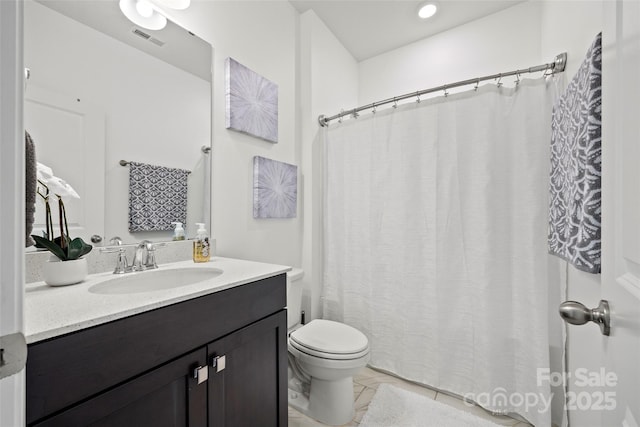 bathroom featuring toilet, tile patterned flooring, and vanity