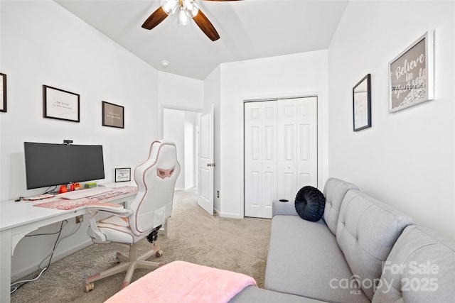 carpeted office space with ceiling fan