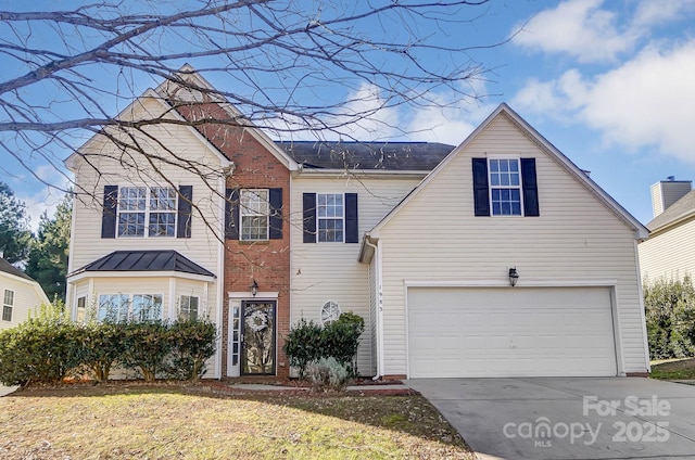 view of front of property with a garage and a front lawn