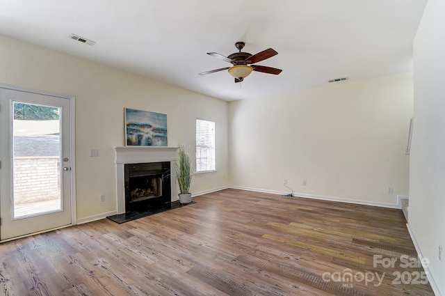 unfurnished living room with hardwood / wood-style flooring and ceiling fan