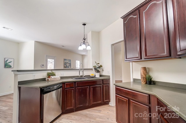 kitchen with dishwasher, sink, an inviting chandelier, light hardwood / wood-style flooring, and pendant lighting