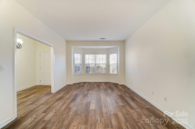 unfurnished room with hardwood / wood-style flooring