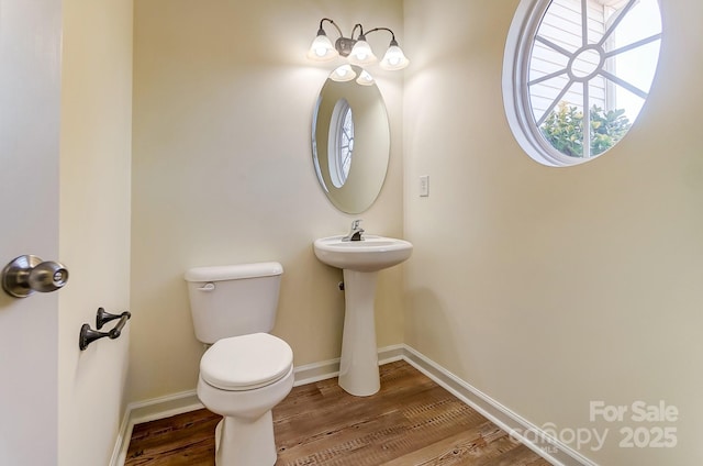 bathroom featuring hardwood / wood-style flooring, toilet, and sink