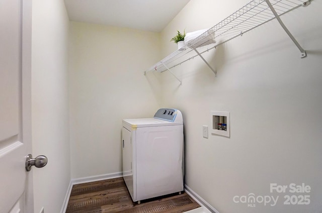 clothes washing area with dark hardwood / wood-style floors and washer / dryer