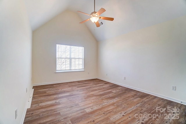 empty room featuring ceiling fan, light hardwood / wood-style floors, and lofted ceiling