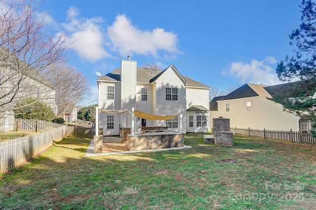 rear view of house with a patio area and a yard