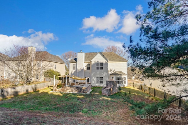 rear view of property featuring a lawn