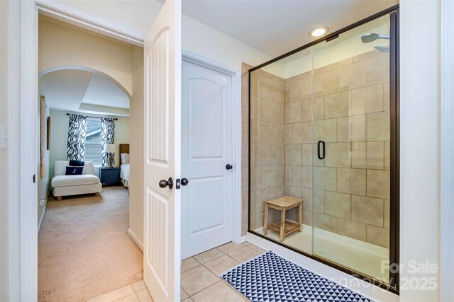 bathroom featuring a shower with door and tile patterned floors