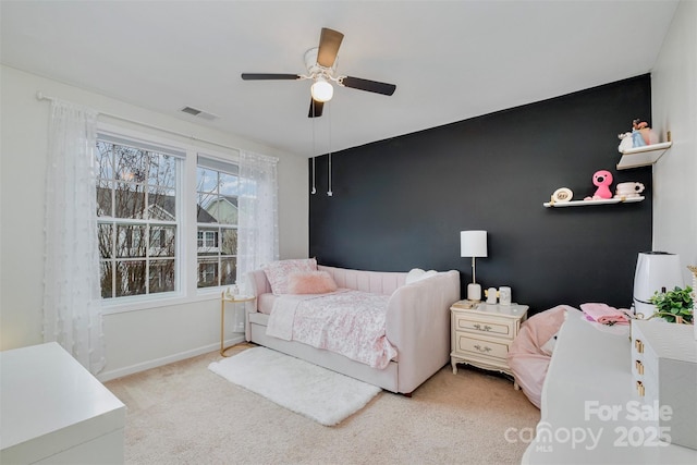 bedroom featuring light carpet and ceiling fan