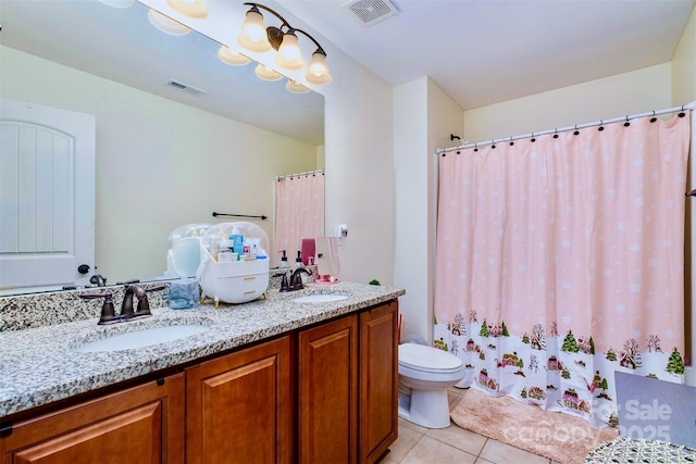 bathroom with vanity, toilet, and tile patterned flooring