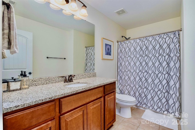 bathroom featuring vanity, curtained shower, tile patterned floors, and toilet