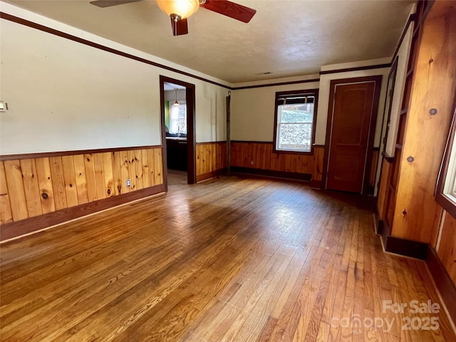 unfurnished room featuring hardwood / wood-style floors, ceiling fan, and ornamental molding