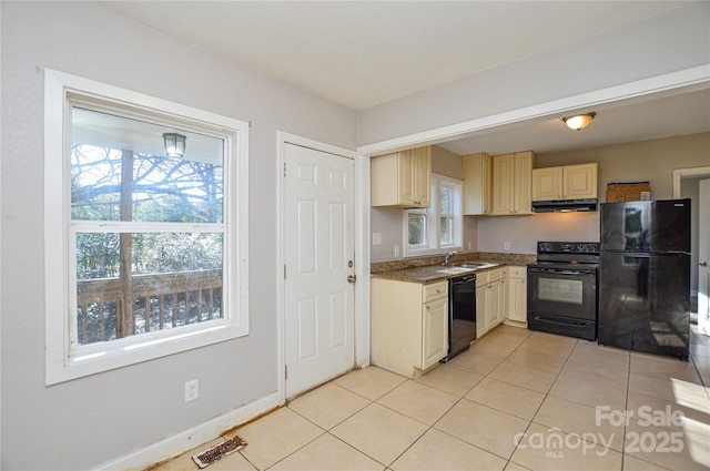 kitchen featuring sink, light tile patterned flooring, and black appliances