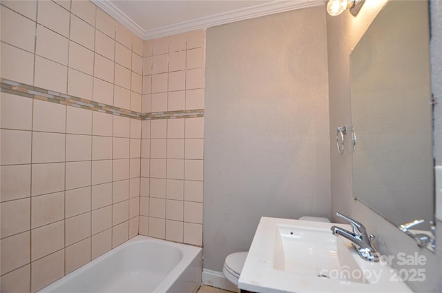 full bathroom featuring toilet, ornamental molding, sink, and tiled shower / bath