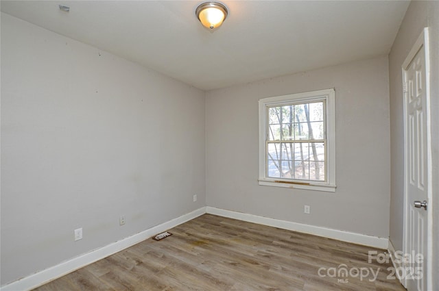 spare room featuring wood-type flooring