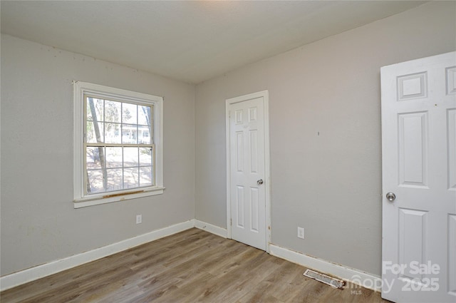 unfurnished room featuring light hardwood / wood-style flooring