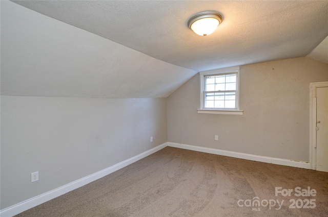 bonus room with carpet flooring, a textured ceiling, and lofted ceiling