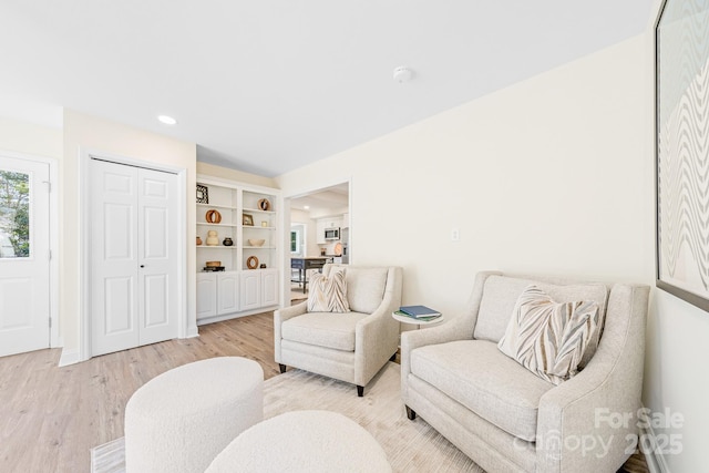 living area with light hardwood / wood-style floors