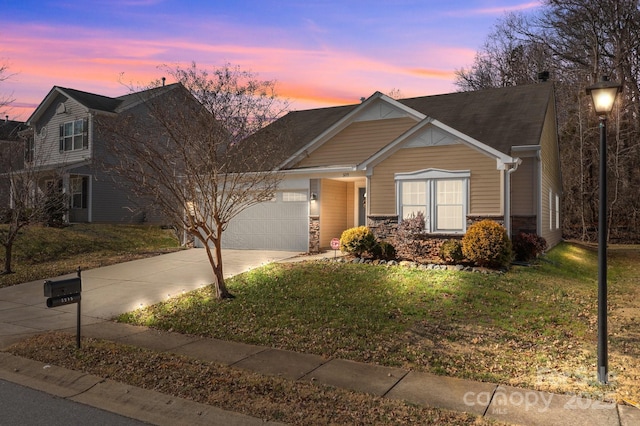 view of front of house with a yard and a garage