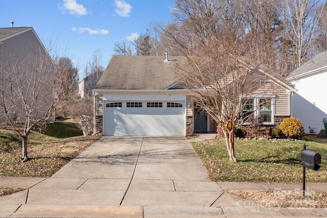 view of front of house with a front yard and a garage