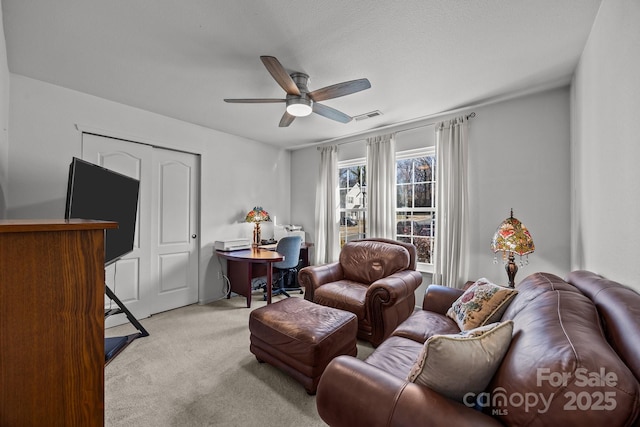 living room featuring light colored carpet and ceiling fan