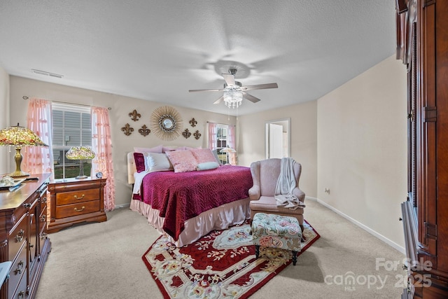 carpeted bedroom with multiple windows, ceiling fan, and a textured ceiling