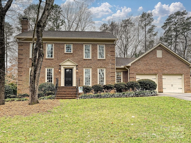 view of front of home with a front yard and a garage