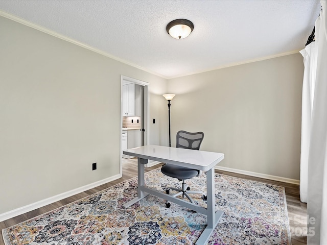 office space featuring a textured ceiling, hardwood / wood-style flooring, and crown molding