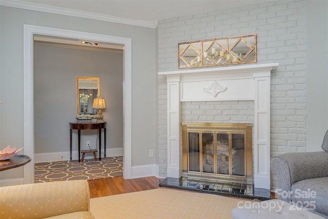 living room featuring ornamental molding, a brick fireplace, and hardwood / wood-style floors