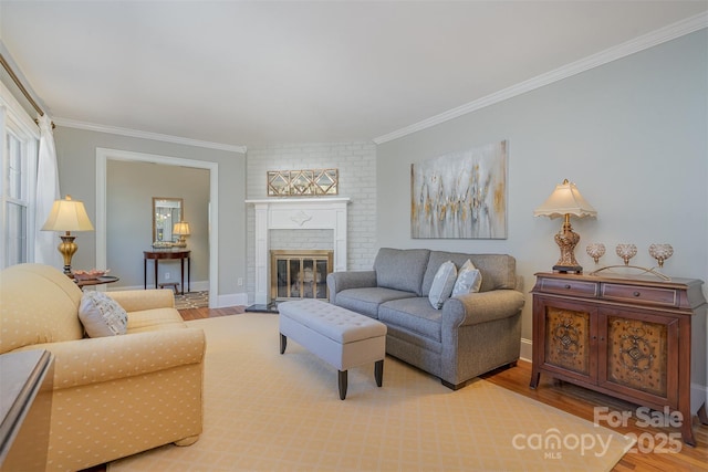 living room with hardwood / wood-style flooring, crown molding, and a brick fireplace